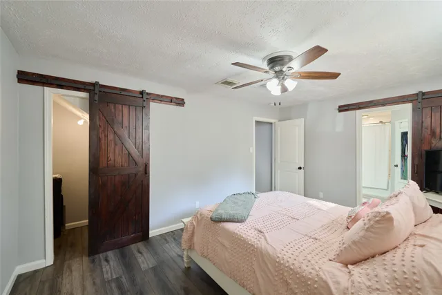a bedroom with a bed chandelier and a window