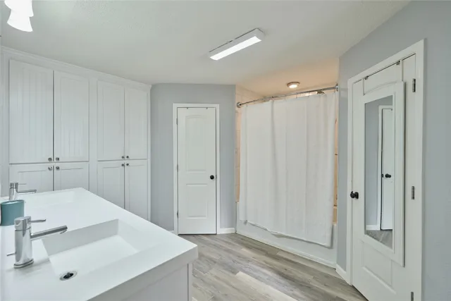 a bedroom with a bed and a ceiling fan