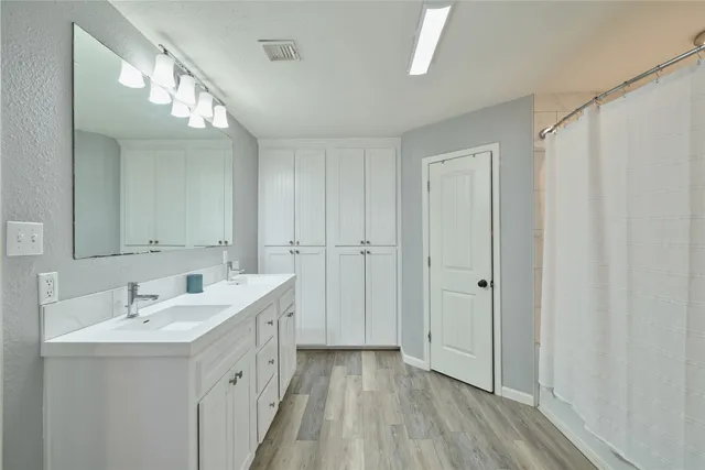 a bathroom with a sink and shower