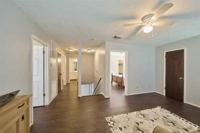 a view of a hallway with wooden floor and cabinet space with wooden floor
