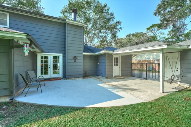 a backyard of a house with table and chairs