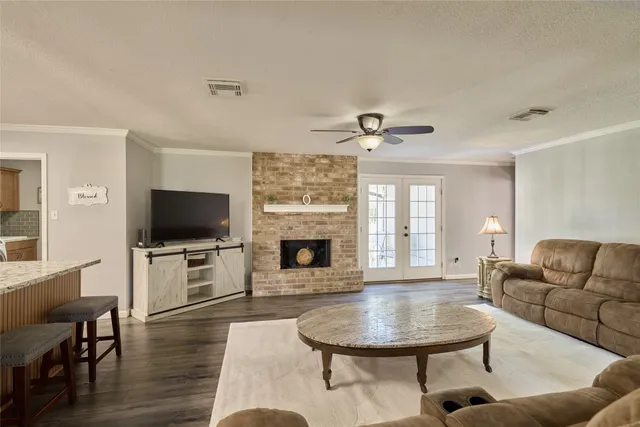 a living room with furniture a fireplace and a flat screen tv