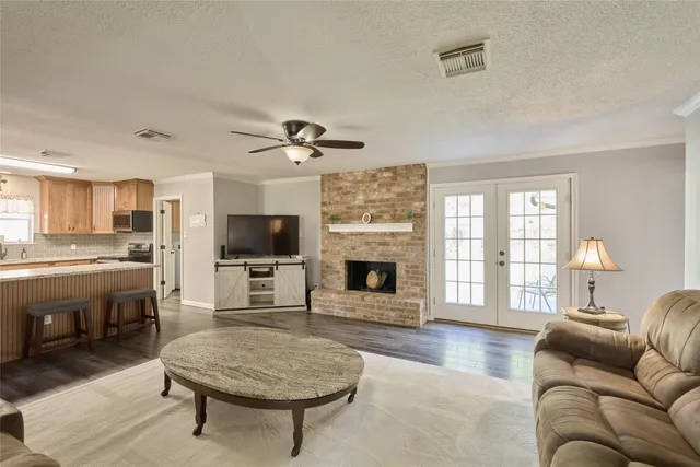 a living room with furniture a flat screen tv and a fireplace
