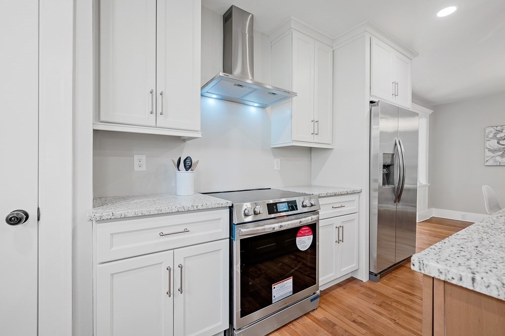47 Brighton Road Worcester, MA 01606 - Photo 15 of 39 a kitchen with granite countertop white cabinets and a stove