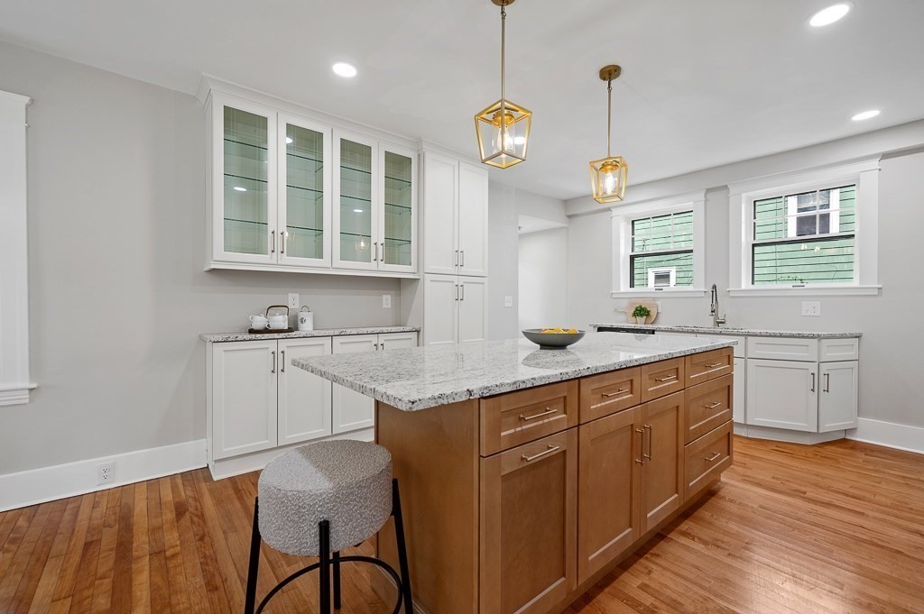 47 Brighton Road Worcester, MA 01606 - Photo 16 of 39 a kitchen with stainless steel appliances granite countertop a sink a stove and a wooden floors