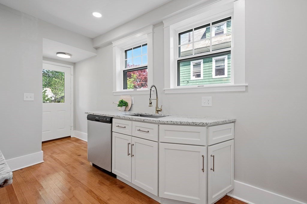 47 Brighton Road Worcester, MA 01606 - Photo 17 of 39 a kitchen with white cabinets and window