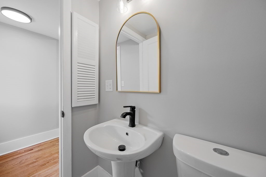 47 Brighton Road Worcester, MA 01606 - Photo 19 of 39 a bathroom with a sink a toilet and mirror
