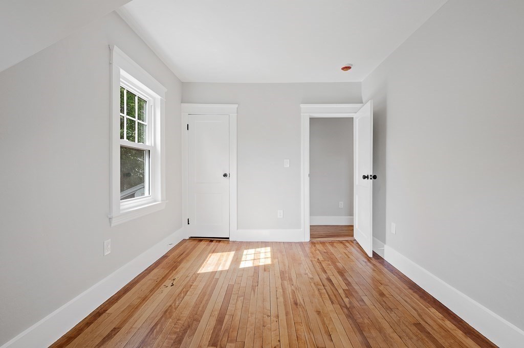 47 Brighton Road Worcester, MA 01606 - Photo 27 of 39 an empty room with wooden floor and windows