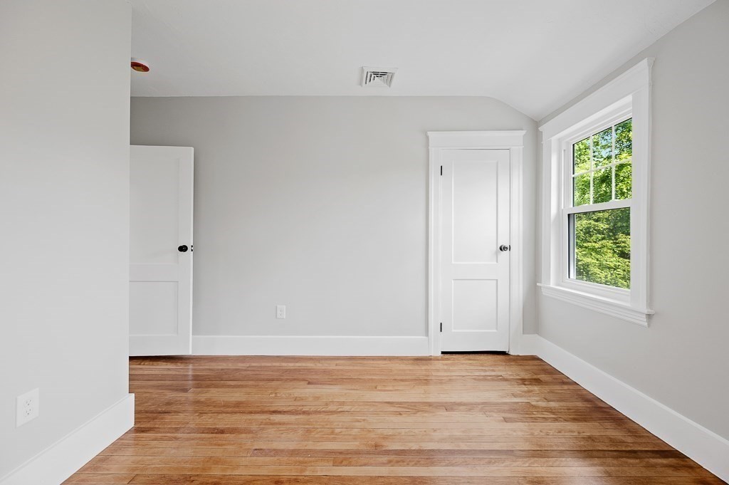 47 Brighton Road Worcester, MA 01606 - Photo 29 of 39 a view of an empty room with wooden floor and a window