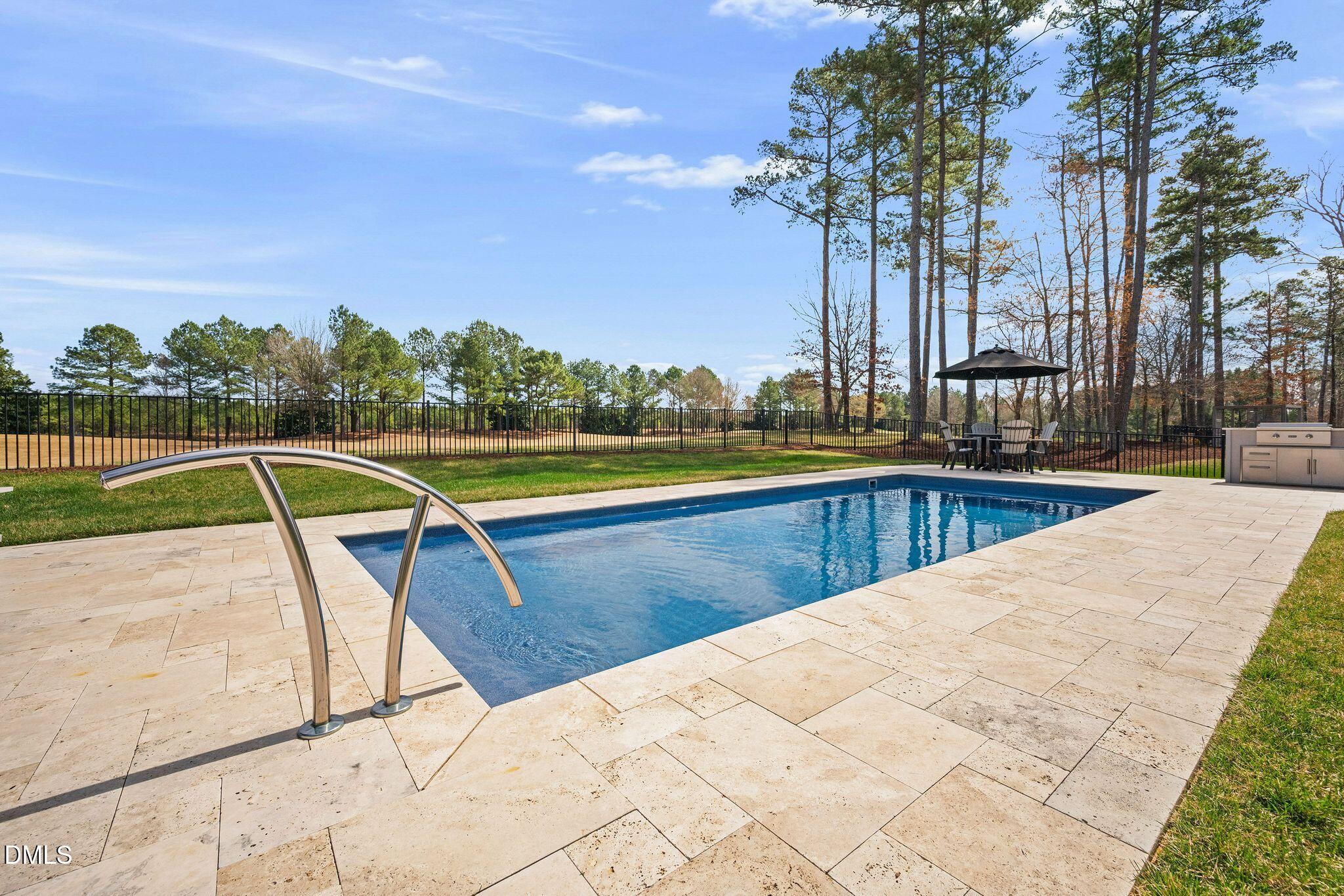 7440 Hasentree Way Wake Forest, NC 27587 - Photo 14 of 64 a view of swimming pool with seating area and trees in the background