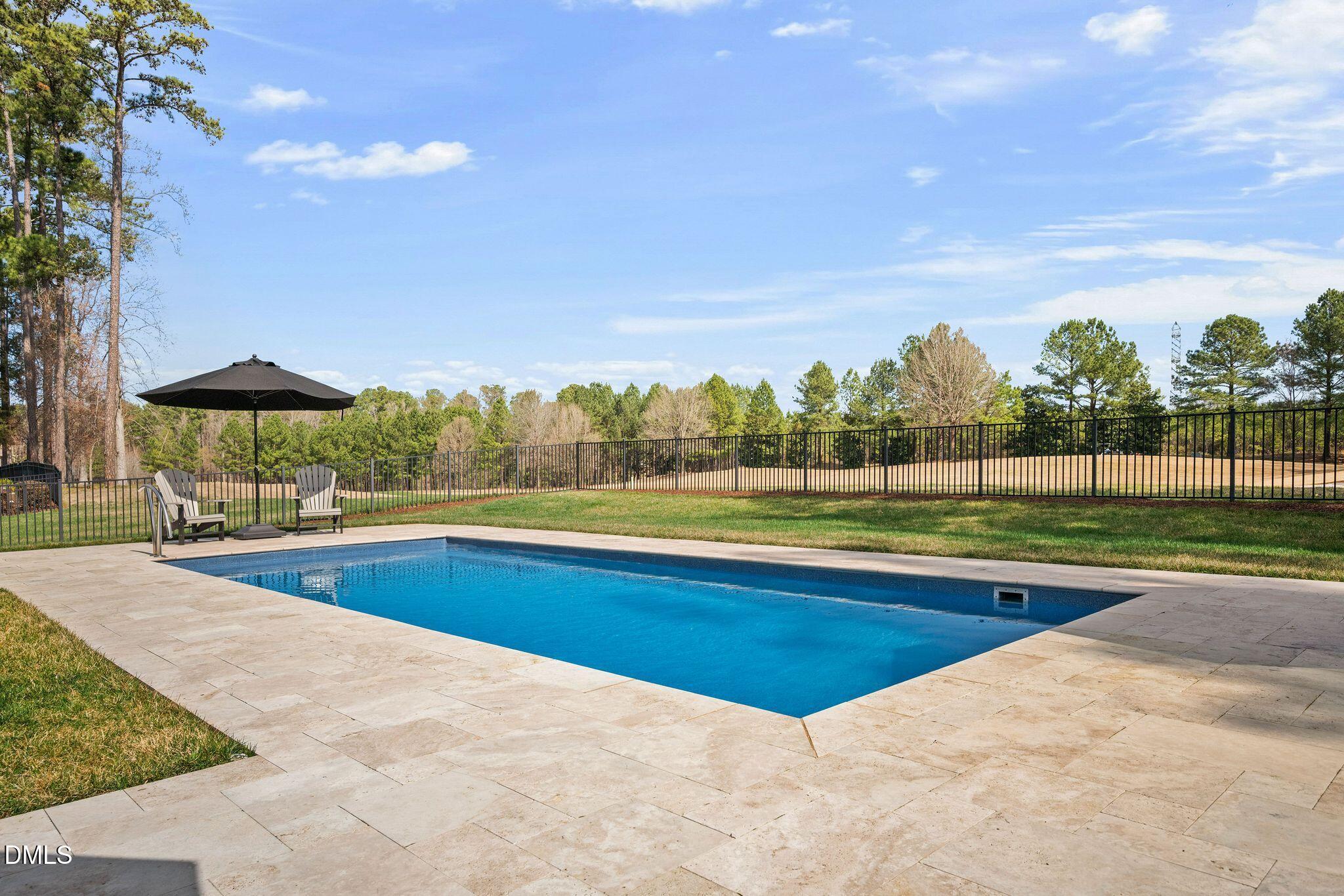 7440 Hasentree Way Wake Forest, NC 27587 - Photo 15 of 64 a view of swimming pool with lawn chairs under an umbrella