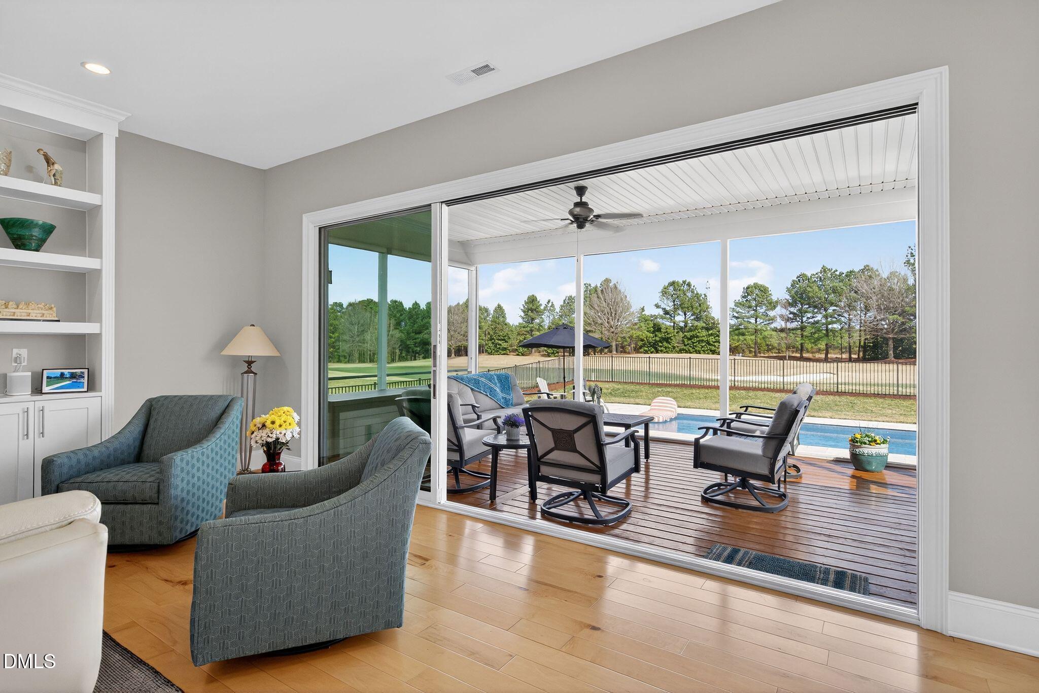 7440 Hasentree Way Wake Forest, NC 27587 - Photo 28 of 64 a living room with furniture and a floor to ceiling window