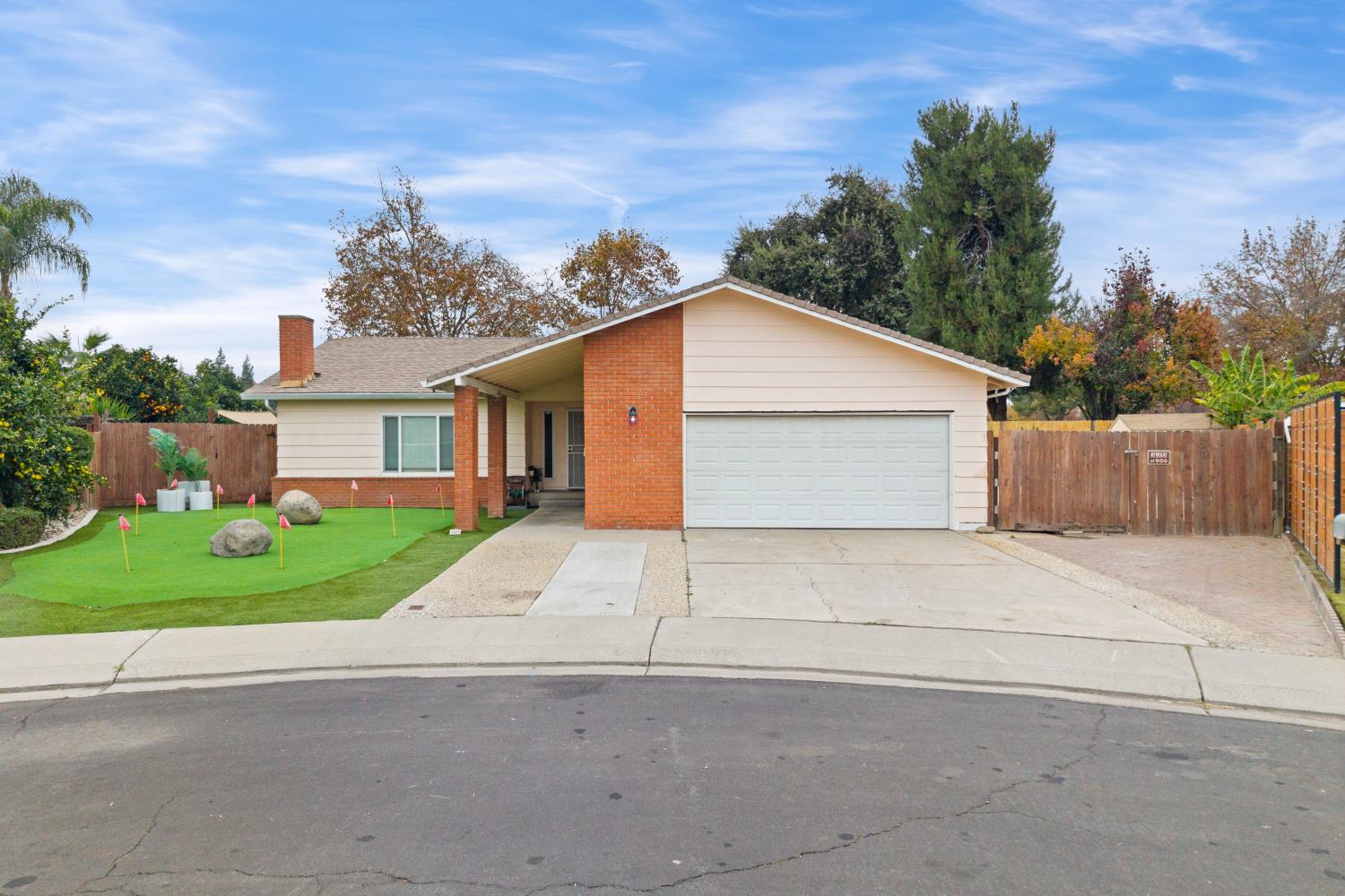 front view of a house with a yard and trees