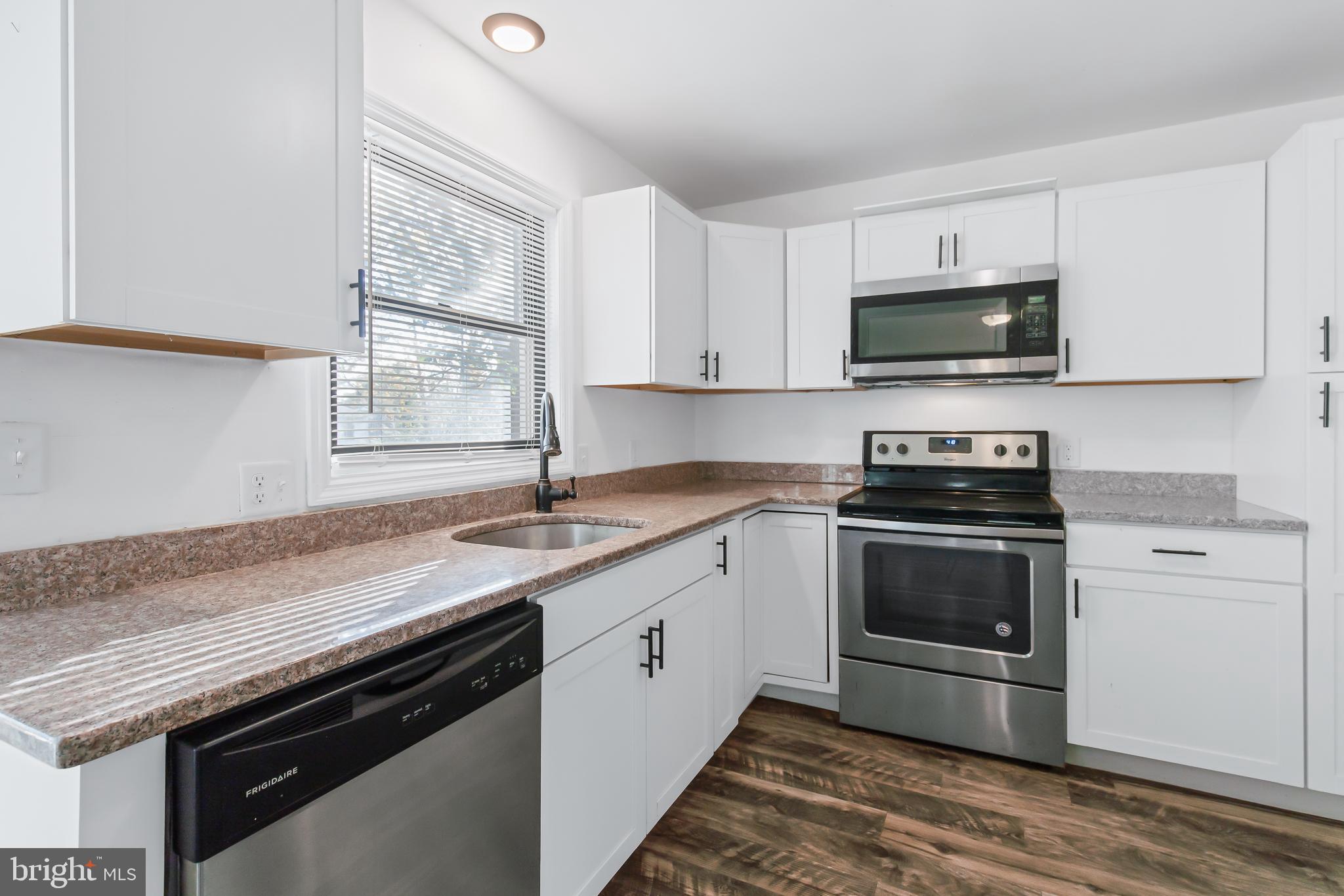403 Cardinal Road Lititz, PA 17543 - Photo 8 of 29 a kitchen with stainless steel appliances granite countertop a sink dishwasher a stove and a microwave oven with cabinets