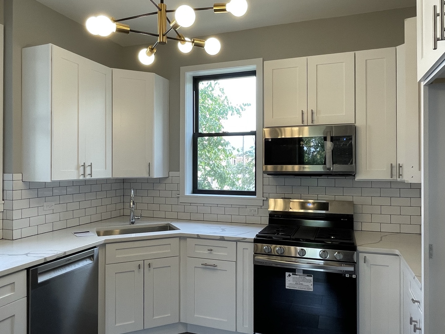 4032 North Wolcott Avenue, Unit 2R Chicago, IL 60613 - Photo 8 of 10 a kitchen with a stove and a sink