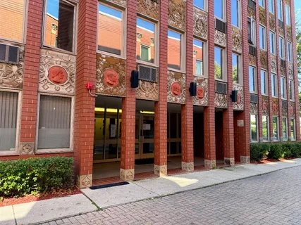 a view of a building with a brick wall