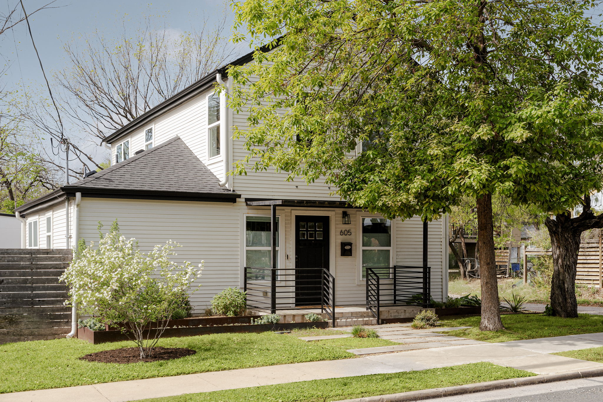 Fresh landscaping, a blooming ornamental tree, and an easy sidewalk path gives the kind of curb presence that makes a home feel cared for before you ever step inside.