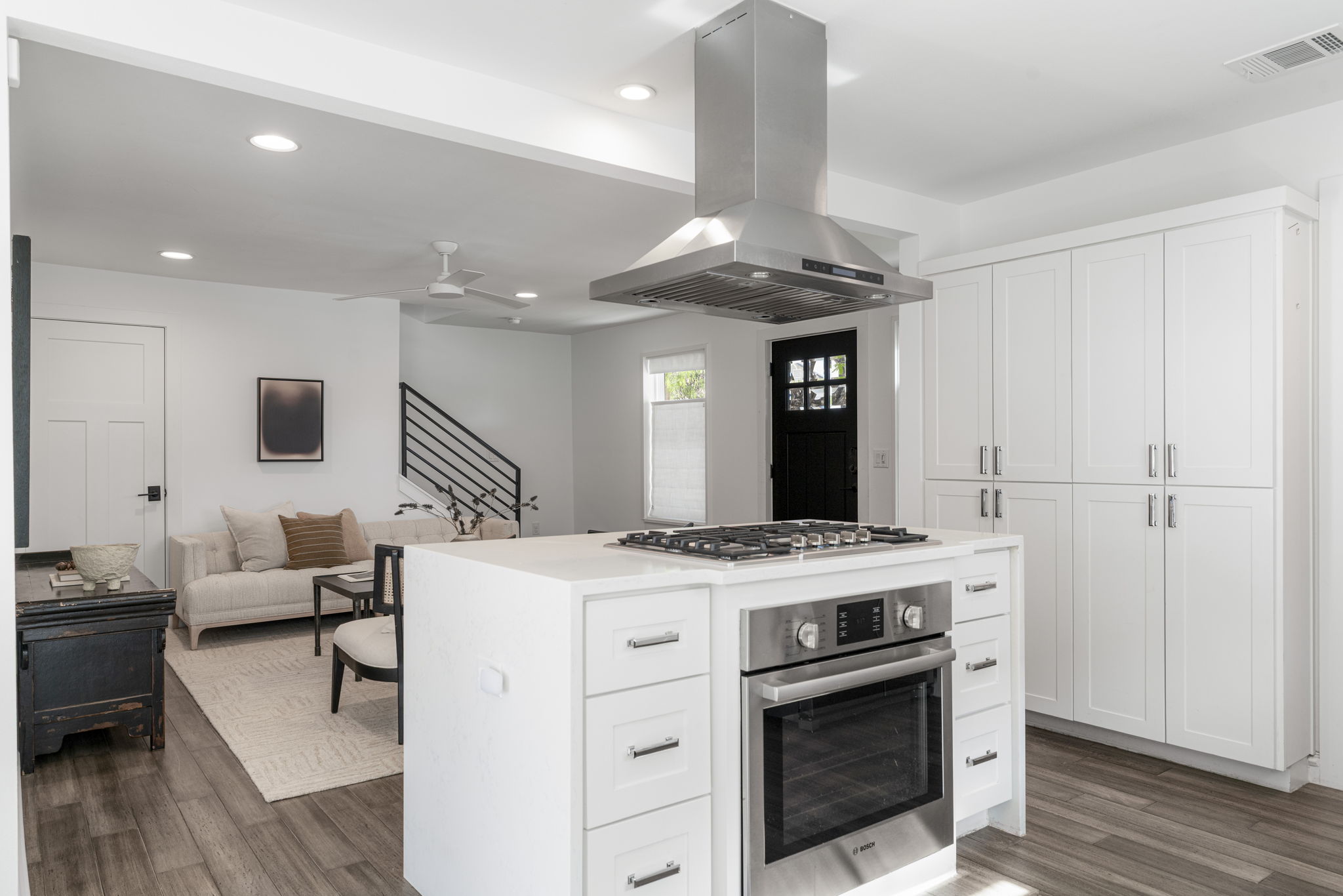 605 Harris Avenue Austin, TX 78705 - Photo 12 of 34 The island earns its place as the true heart of this kitchen with the gas cooktop and built-in oven. And the floor-to-ceiling pantry cabinetry makes storage feel effortless.