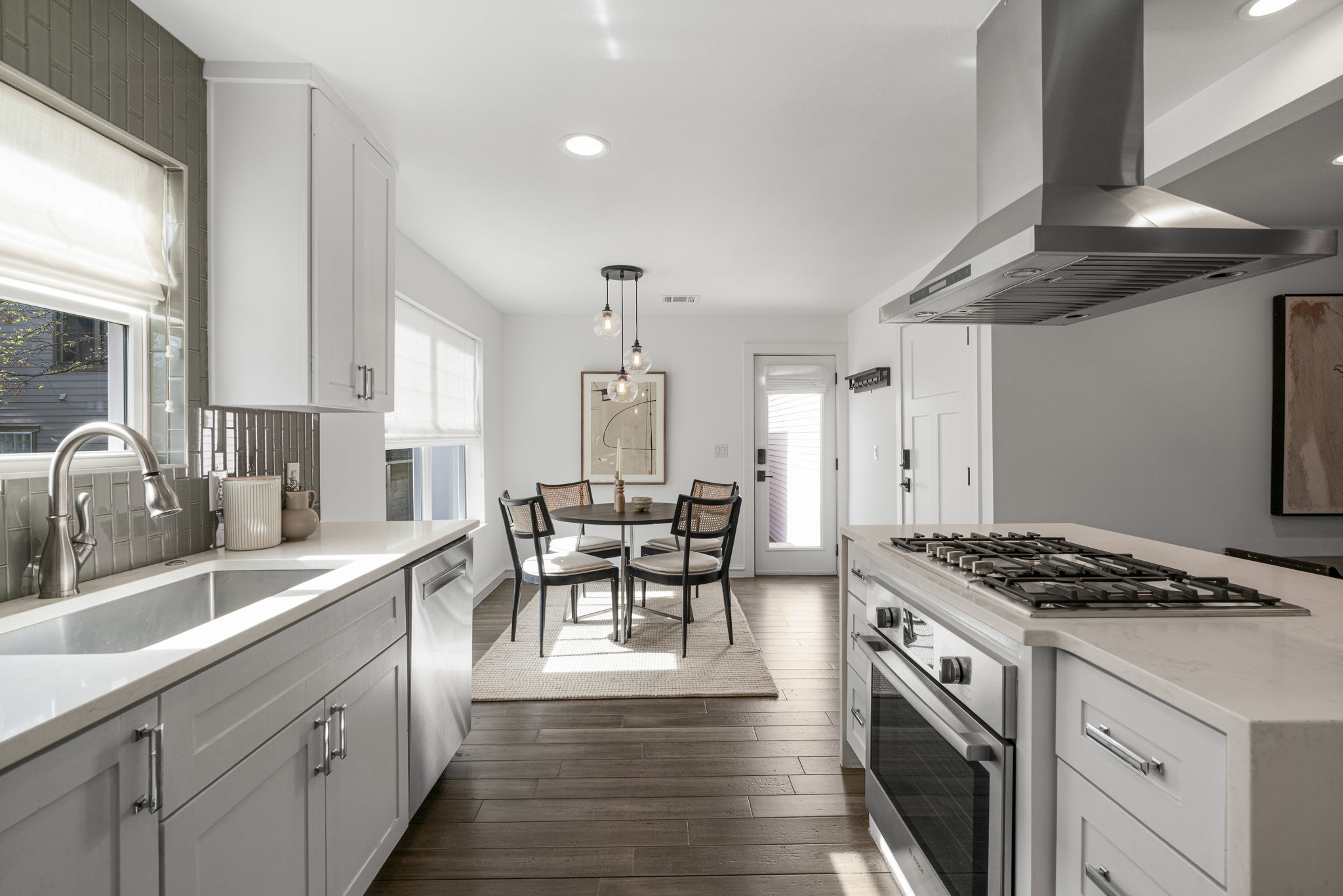 605 Harris Avenue Austin, TX 78705 - Photo 14 of 34 Every detail in this kitchen was chosen with care. Sage green tile, quartz countertops, Bosch stainless steel appliances, and a sunny dining nook just beyond.
