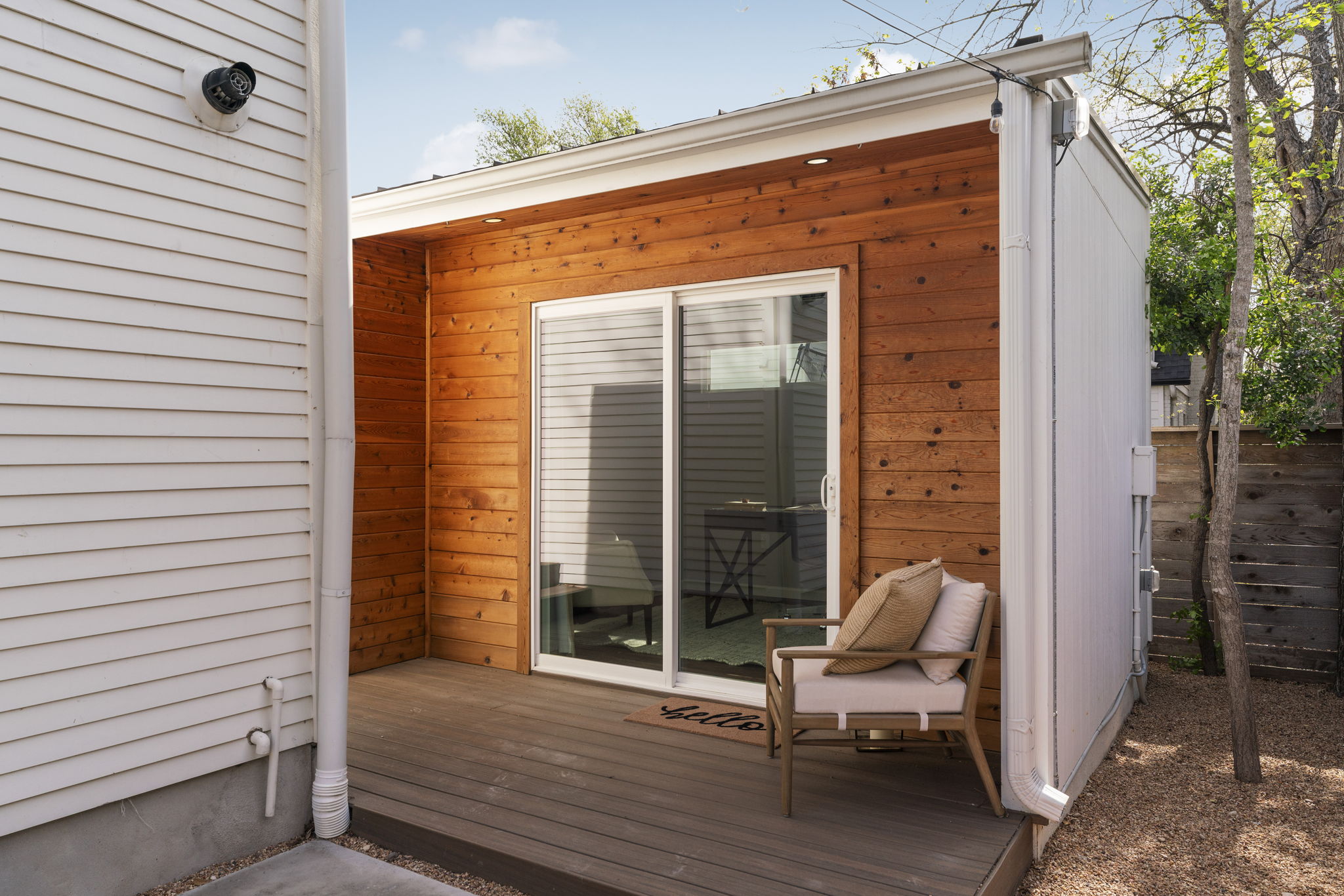605 Harris Avenue Austin, TX 78705 - Photo 3 of 34 The office pod has its own intentional and charming sense of arrival with warm cedar siding, a sliding glass door, and a small deck.