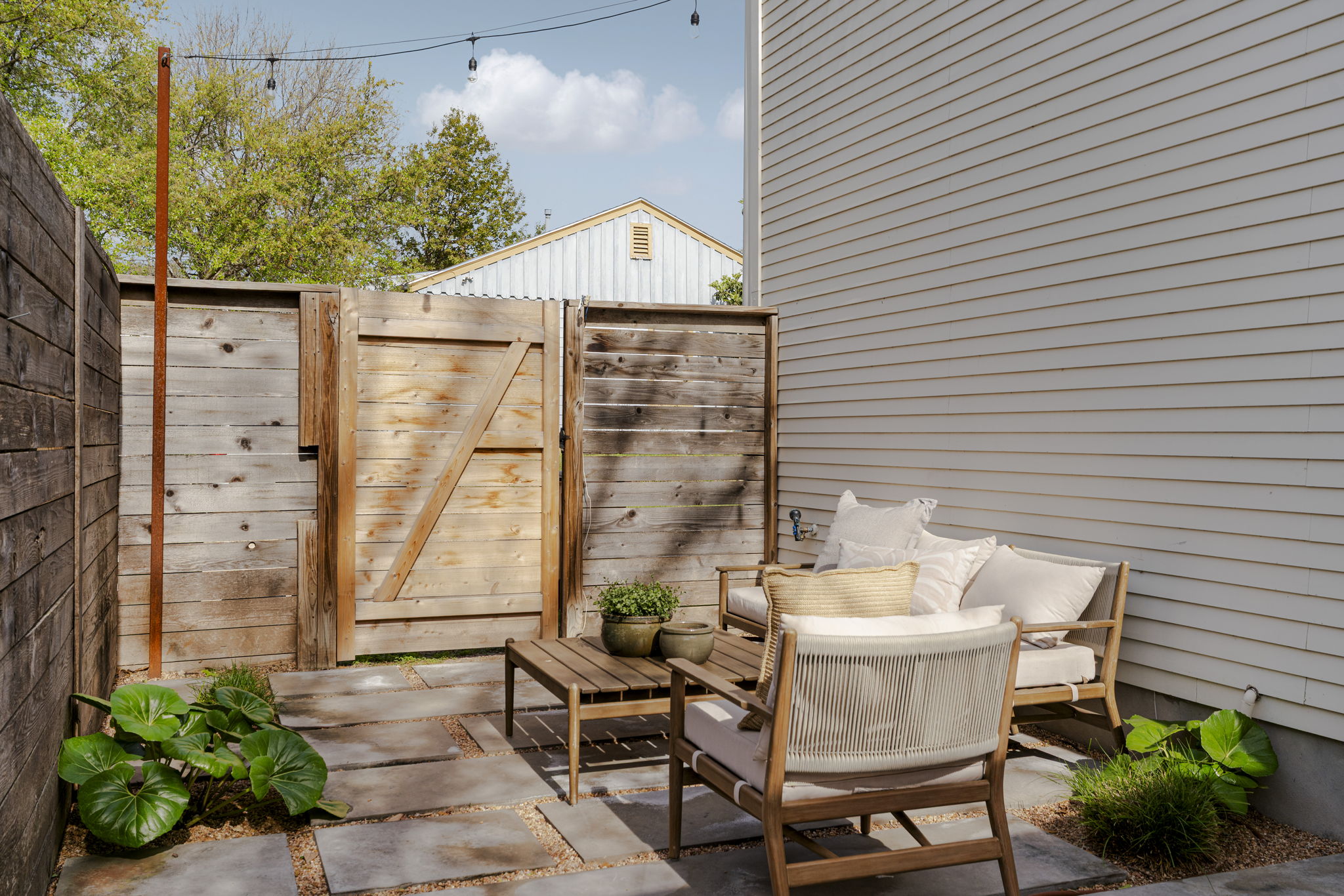 605 Harris Avenue Austin, TX 78705 - Photo 31 of 34 A quiet, private courtyard great for a morning coffee spot, an evening gathering space, or simply a peaceful place to just sit. The mature plantings and horizontal fence give it a sense of enclosure that feels intentional, not cramped.