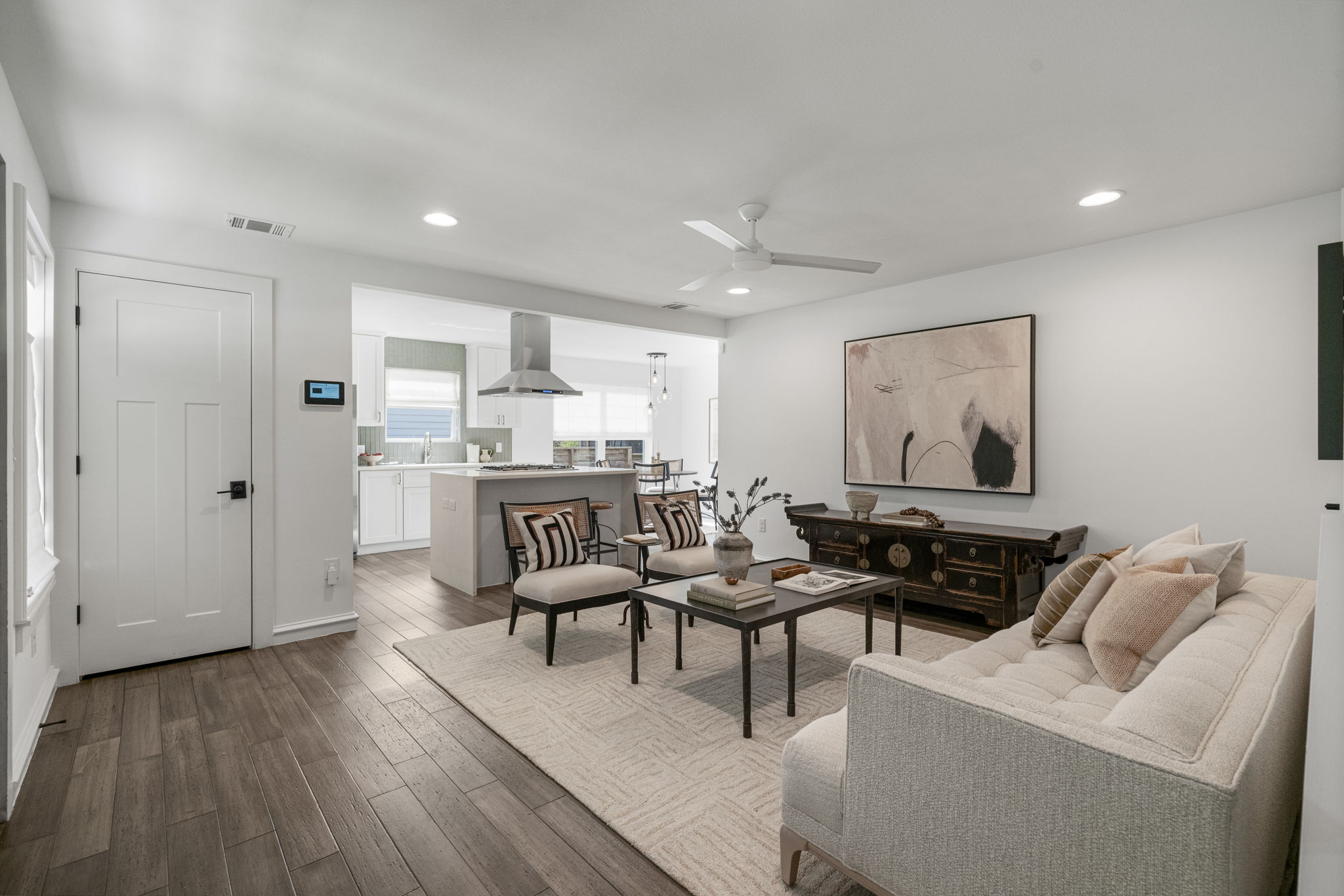 605 Harris Avenue Austin, TX 78705 - Photo 4 of 34 From the moment you walk in, the space feels warm and considered. The living area opens straight into the kitchen, with just enough definition between the two to feel intentional.