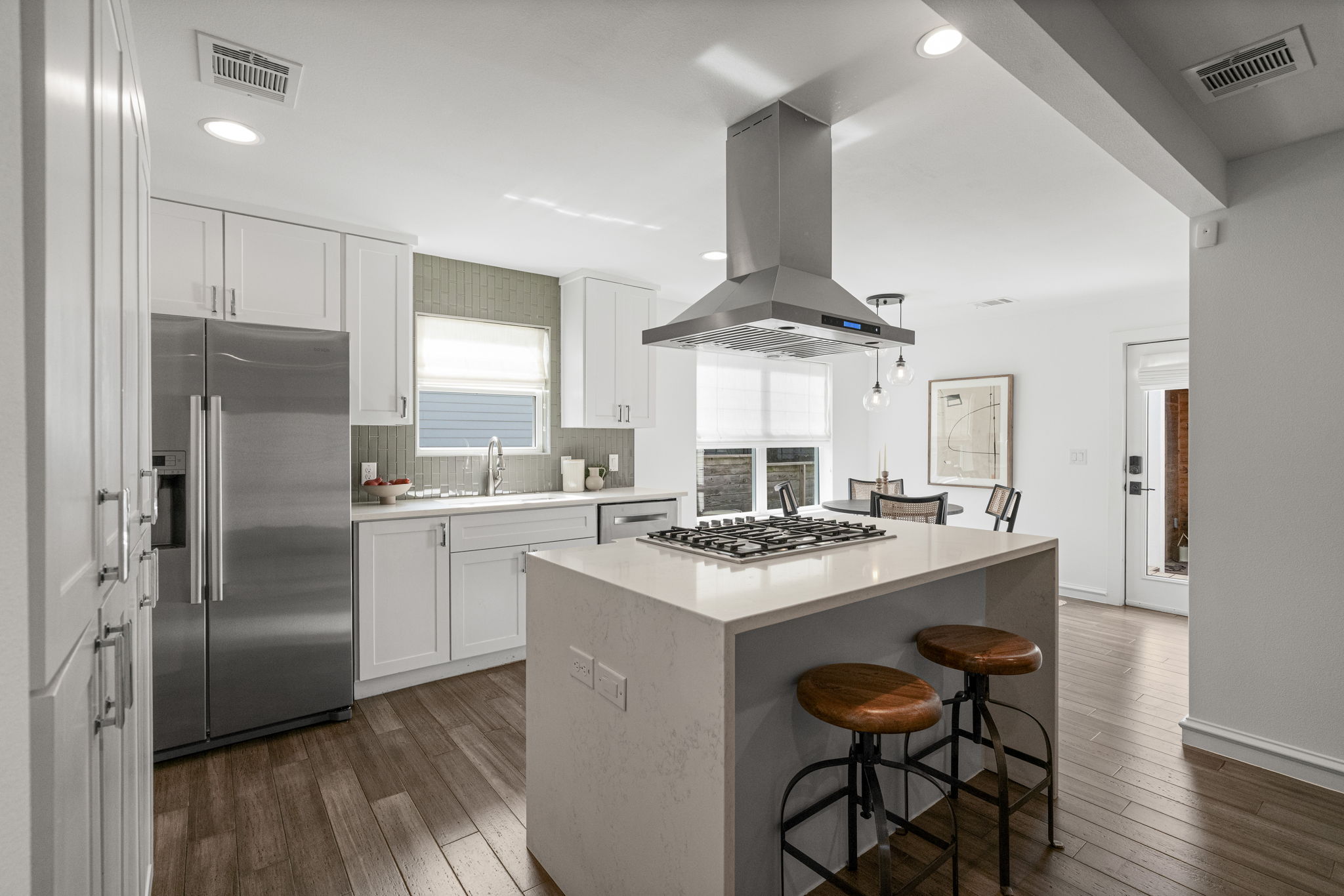 605 Harris Avenue Austin, TX 78705 - Photo 5 of 34 The quartz island with its statement range hood anchors a kitchen designed for real cooking and easy gathering.
