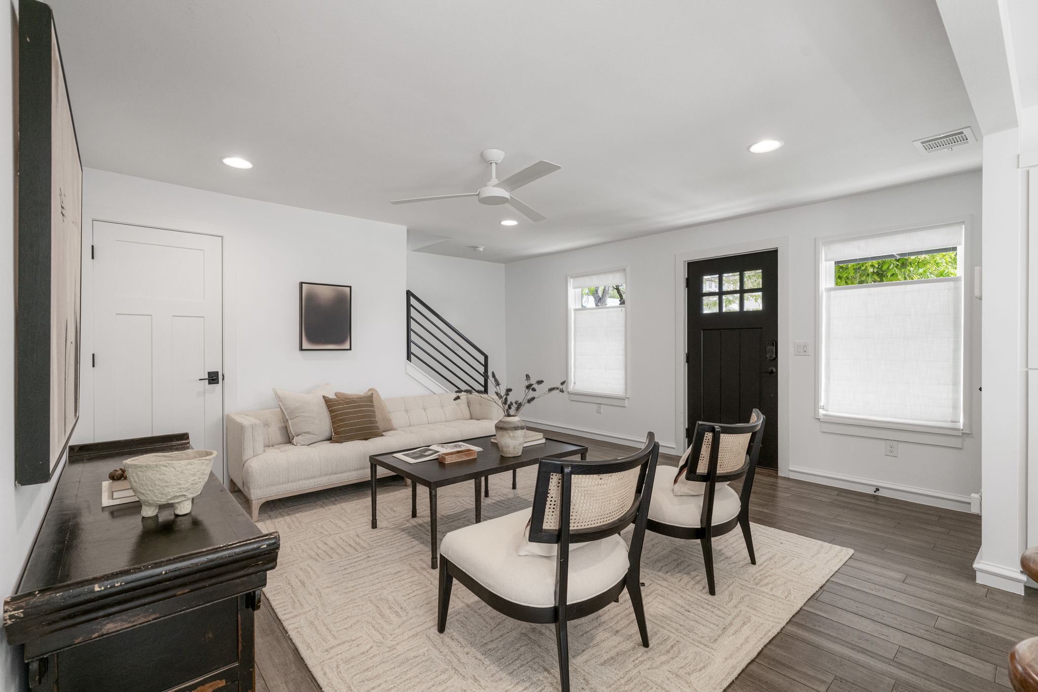 605 Harris Avenue Austin, TX 78705 - Photo 9 of 34 Clean lines, warm tones, and a modern black steel staircase that feels like a design feature as much as a functional one.