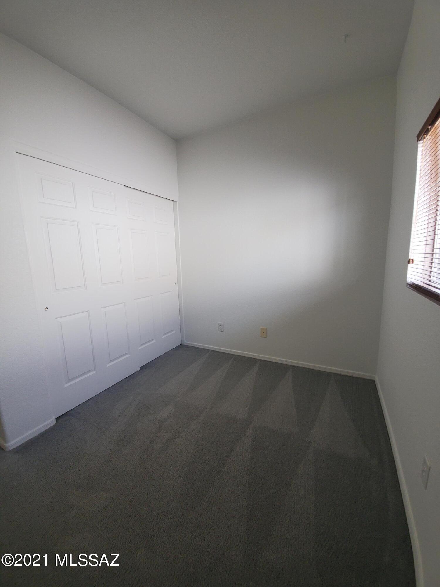 3455 North Boyce Spring Lane Tucson, AZ 85745 - Photo 12 of 21 an empty room with a empty space and window