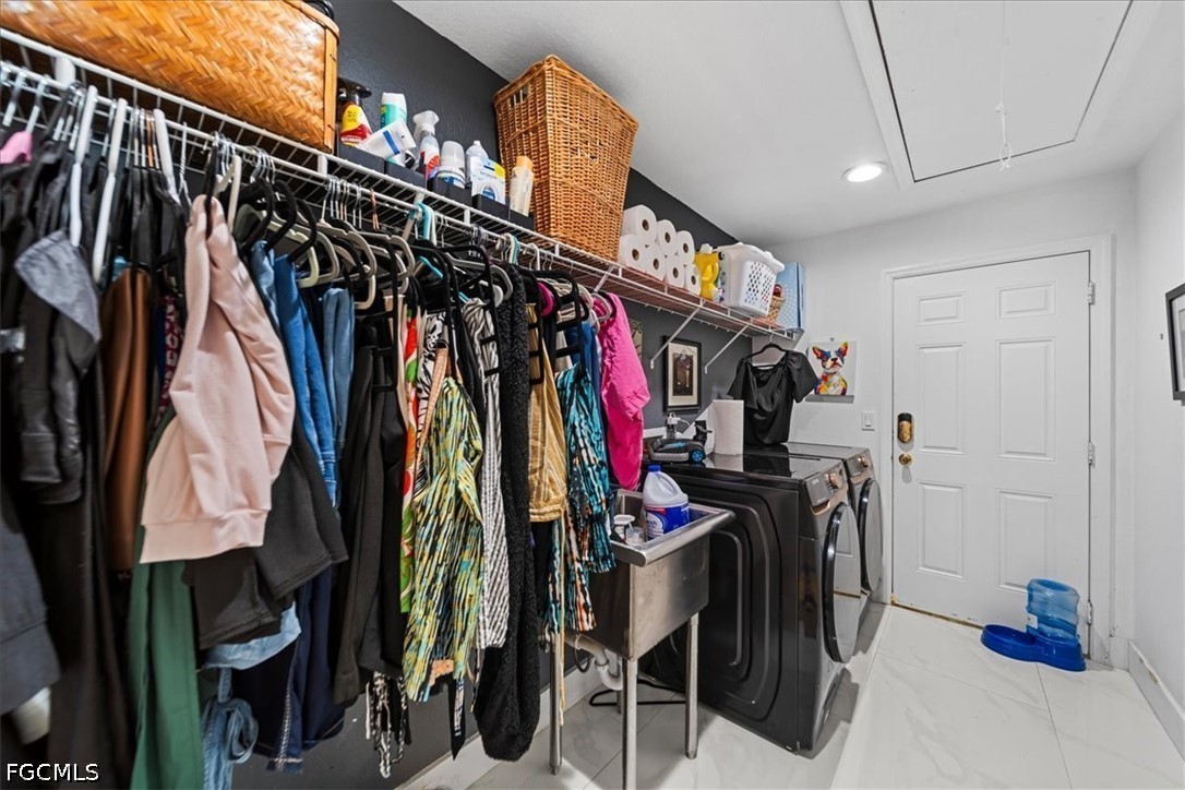 22 Nelson Road South Cape Coral, FL 33991 - Photo 32 of 43 a view of walk in closet with clothes and shoes
