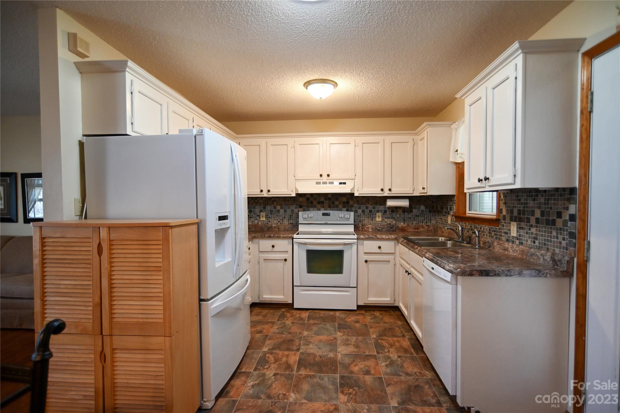 2965 Greenleaf Road Clover, SC 29710 - Photo 15 of 30 a kitchen with stainless steel appliances granite countertop a refrigerator and white cabinets