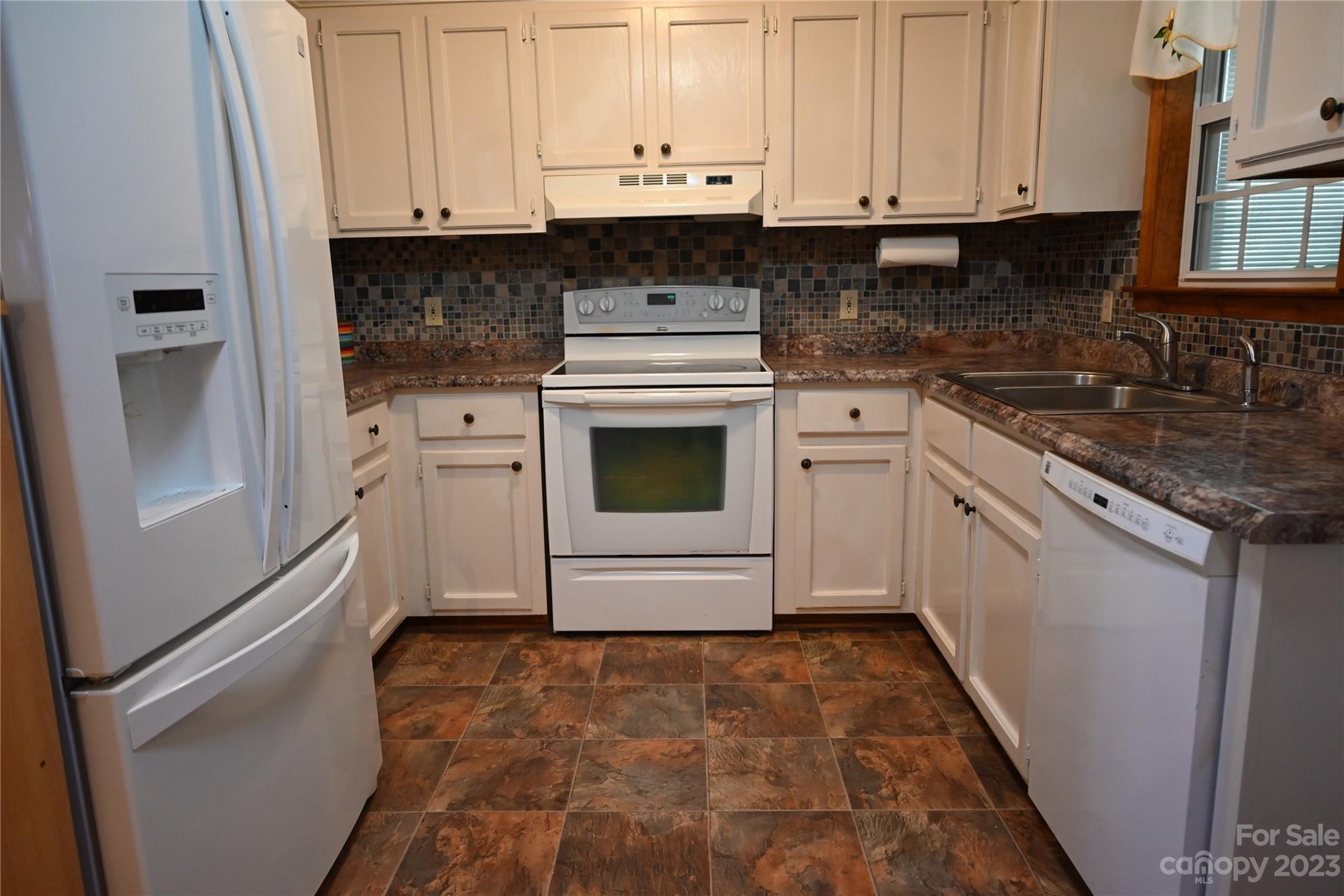 2965 Greenleaf Road Clover, SC 29710 - Photo 16 of 30 a kitchen with granite countertop white cabinets and white appliances