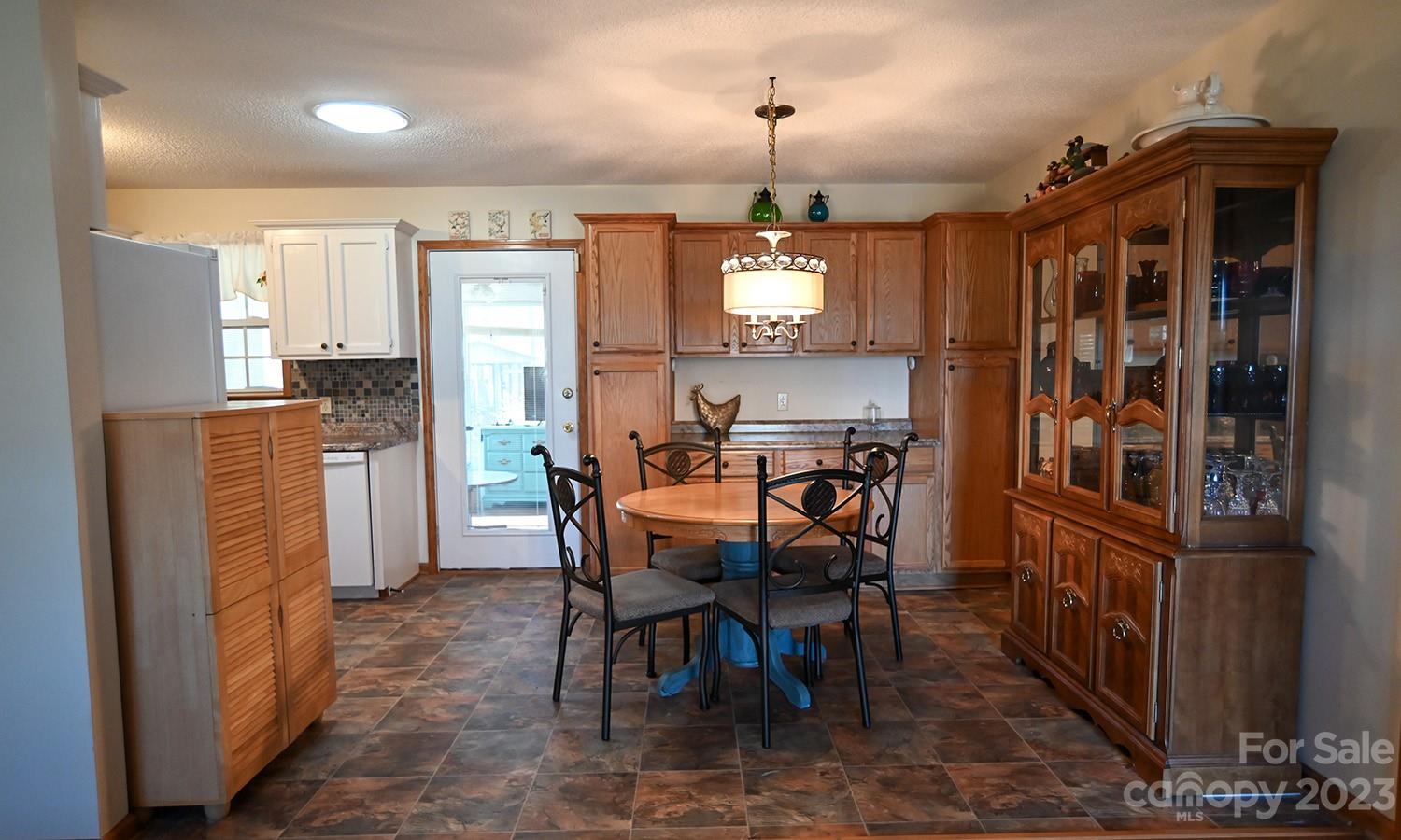 2965 Greenleaf Road Clover, SC 29710 - Photo 17 of 30 a view of a dining room with furniture and a chandelier