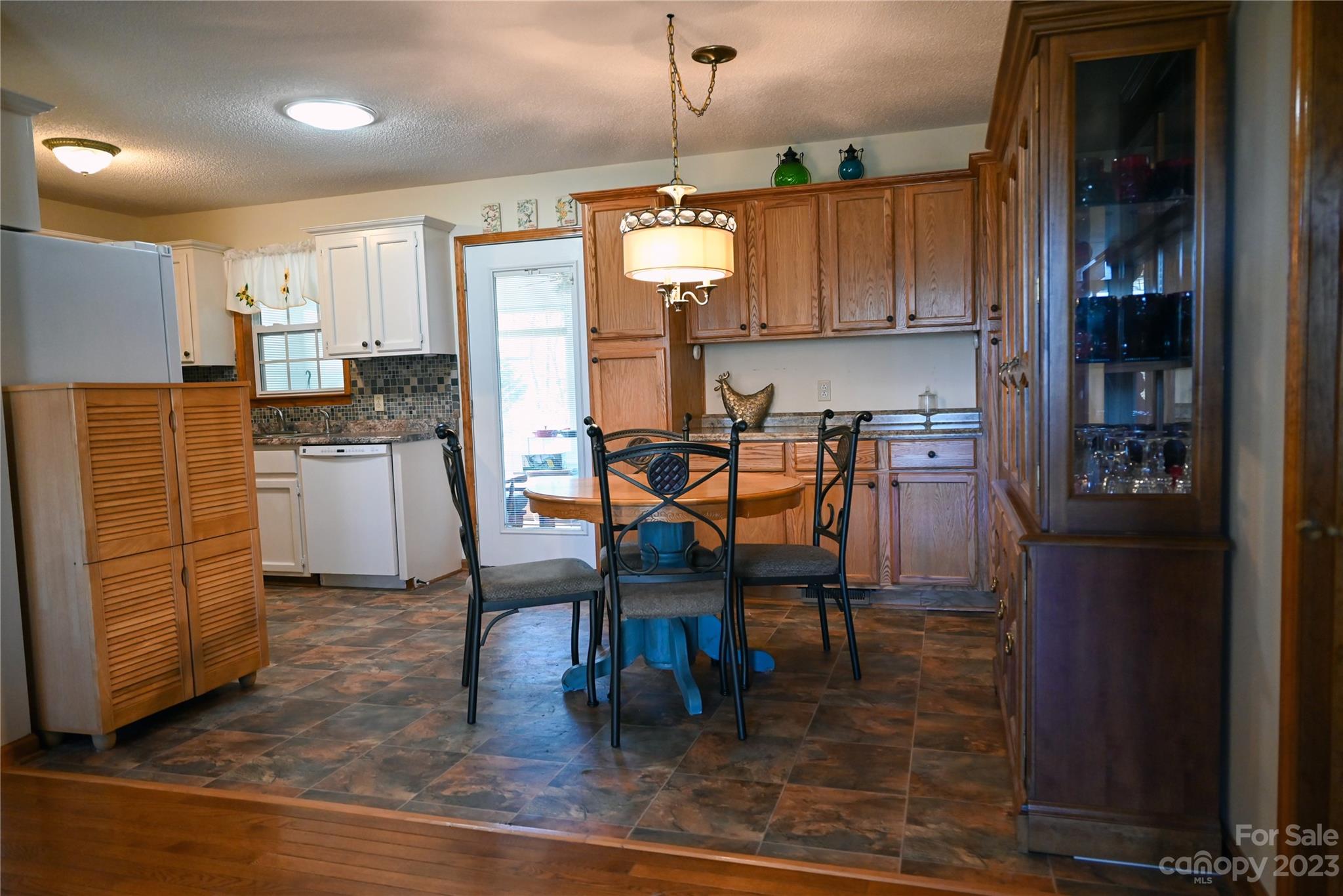 2965 Greenleaf Road Clover, SC 29710 - Photo 22 of 30 a kitchen with stainless steel appliances kitchen island granite countertop dining table chairs and a refrigerator