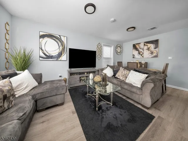 a living room with furniture a large window and a flat screen tv