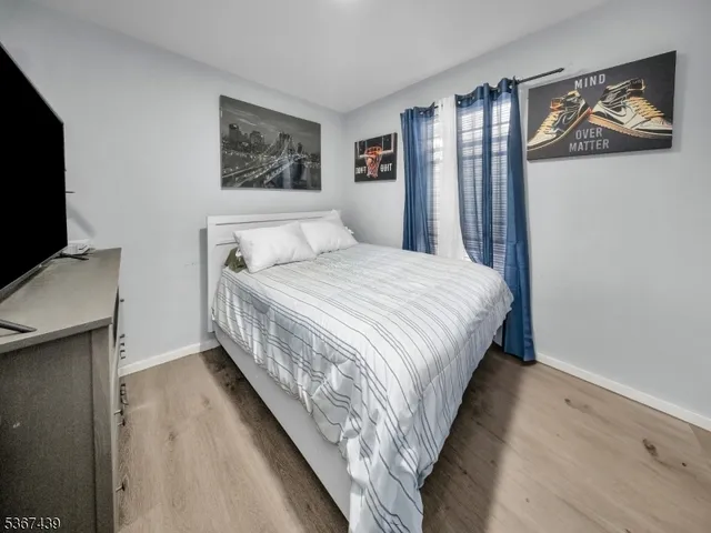 a bedroom with bed and a flat screen tv