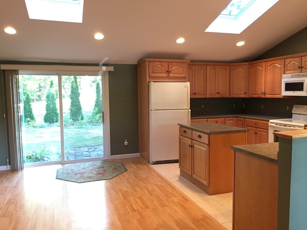 177 West Autumn Road West Springfield, MA 01089 - Photo 5 of 12 a kitchen with a refrigerator a stove top oven a sink and a large window