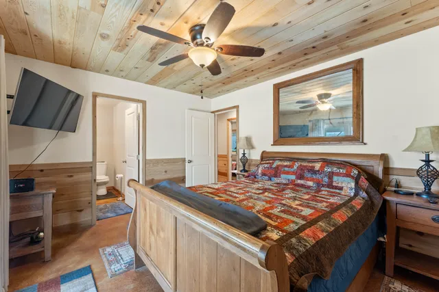 a view of a swimming pool with lawn chairs and a big yard