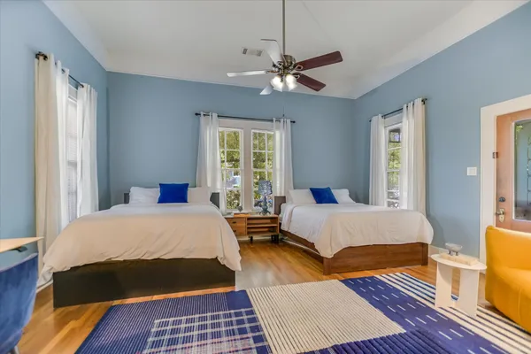 a bedroom with a bed lamp and a rug