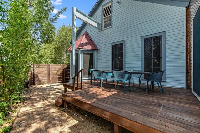 a view of backyard with deck and outdoor seating