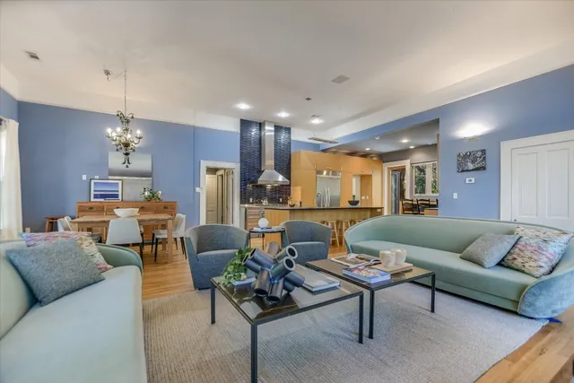 a living room with furniture and kitchen view