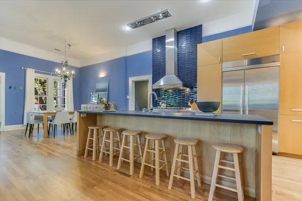 a kitchen with table chairs sink and cabinets