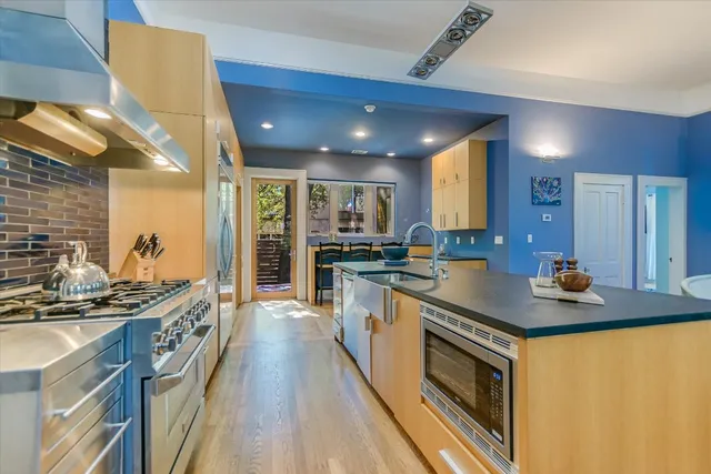 a kitchen with stainless steel appliances granite countertop a stove and a sink