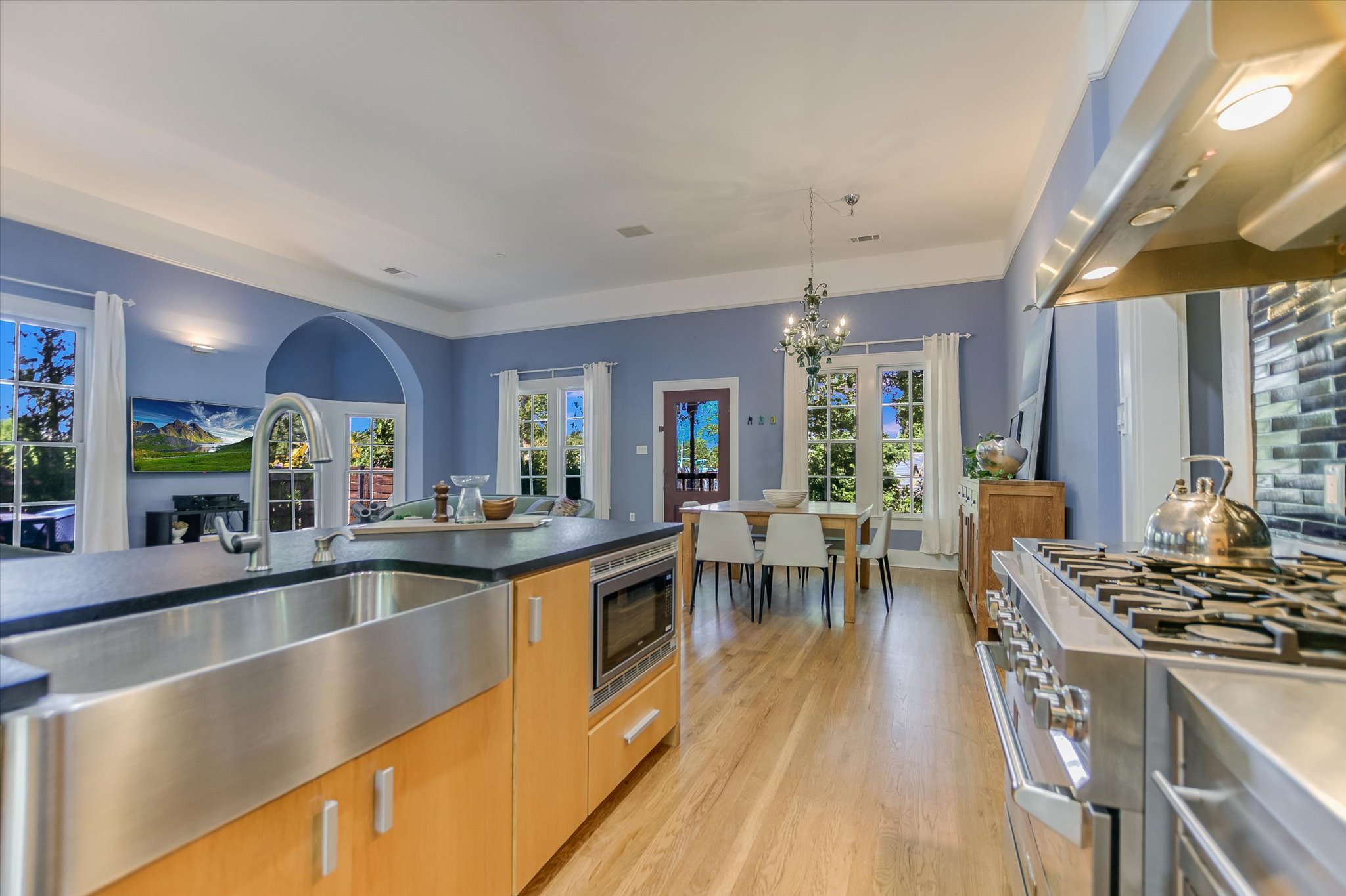 2109 Nickerson Street Austin, TX 78704 - Photo 7 of 23 a view of a kitchen with kitchen island a large counter top space a sink stainless steel appliances and cabinets