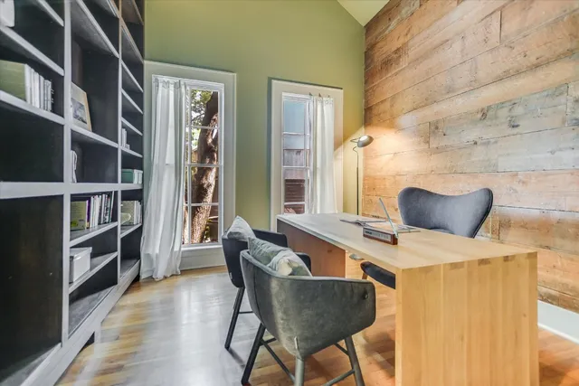 a dining room with furniture and a book shelf