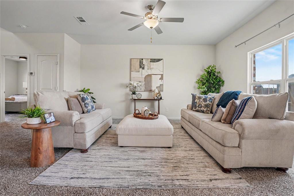 125 Sammy Venus, TX 76084 - Photo 7 of 39 Spacious living area featuring neutral-toned carpeting, white walls, a multi-pane window, and a ceiling fan with integrated lighting