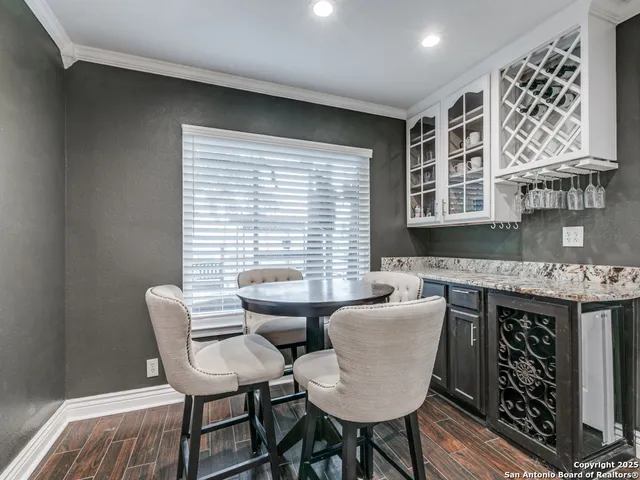 a dining room with furniture and wooden floor
