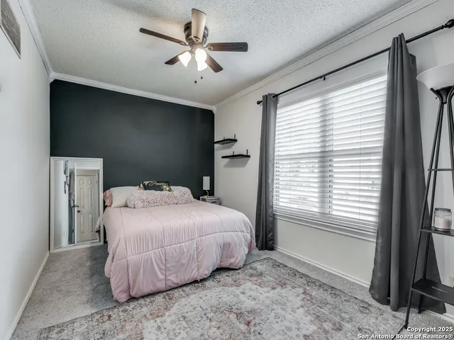 a bedroom with a bed and a large window