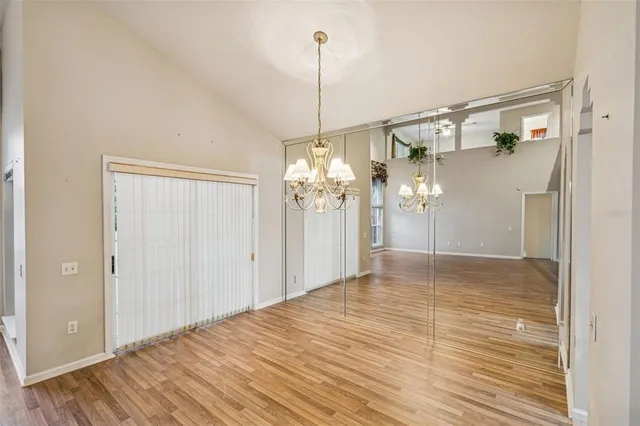 a view of a room with wooden floor and windows