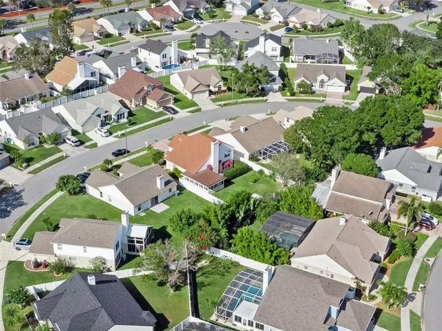 an aerial view of residential houses with outdoor space and street view